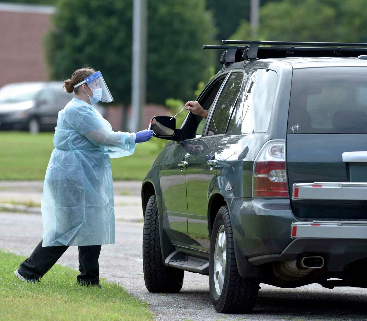 Heidi Bettcher, RN, Public Health Nurse, dispenses a self administered COVID test swab during the first day of the New Milford Health Department's COVID-19 drive-thru testing site at John Pettibone Community Center. Wednesday, August 11, 2021, New Milford, Conn.
