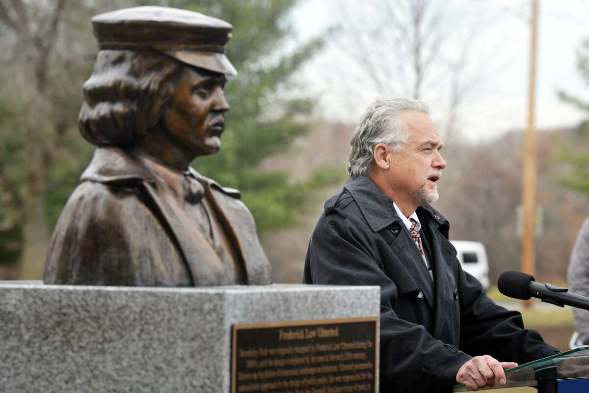 State DOT Commissioner Joseph Giulietti speaks during an unveiling ceremony for a new bust of Frederick Law Olmsted in Beardsley Park, in Bridgeport, Conn. Nov. 30, 2021. Olmsted designed the park in the 1880s and the new bust of his likeness was dedicated to mark the upcoming 200th anniversary of his birth in 1822.