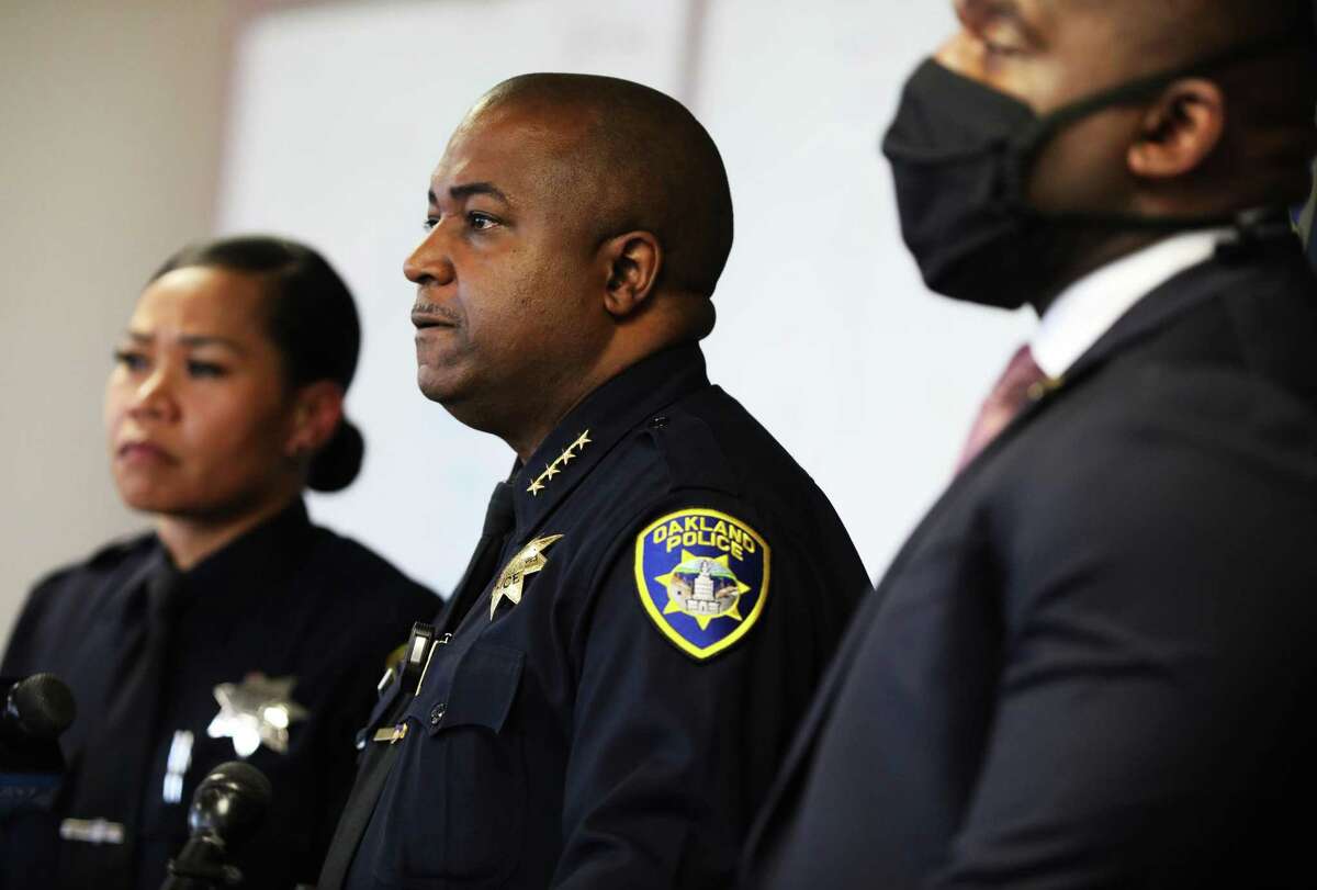 Public information officer Kim Armstead (left), Chief of Police LeRonne Armstrong, and Lt. Frederick Shavies, homicide section commander, all of the Oakland Police Department, listen to a question during a press conference at OPD headquarters.