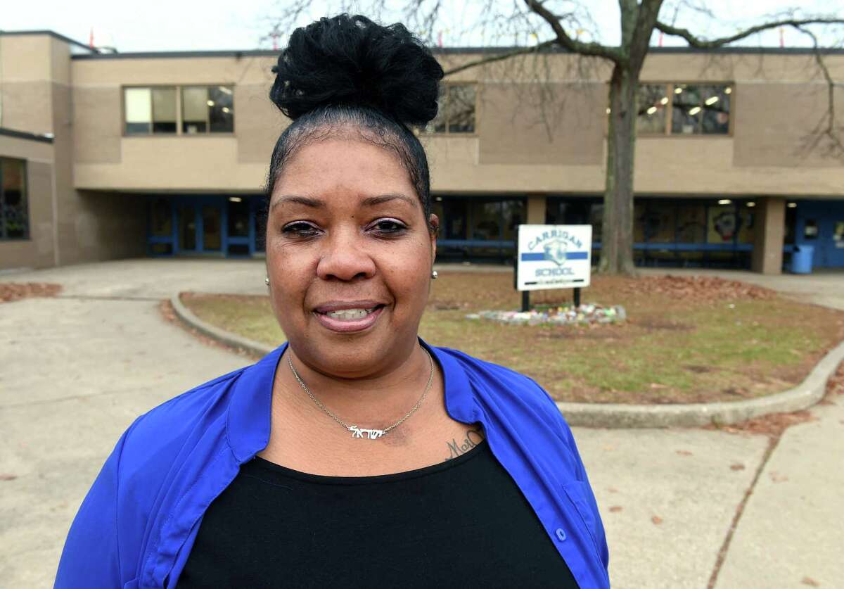 Portia Bias is photographed in front of Carrigan School in West Haven Nov. 30, 2021, where she works as a paraprofessional.