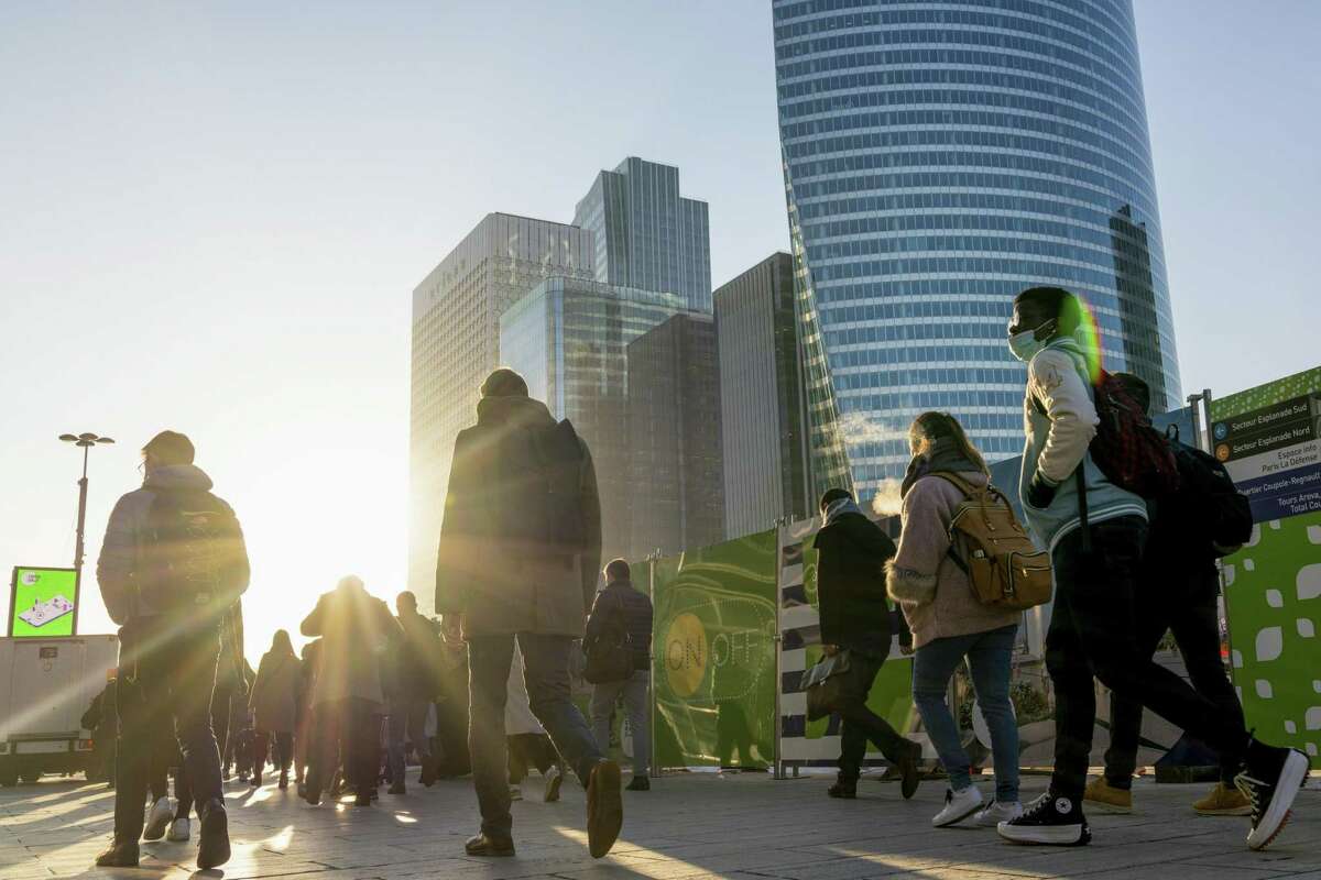 Commuters in the La Defense financial district of Paris, France, on Wednesday, Nov. 10, 2021. French President Emmanuel Macron sought to rally the French and encourage them to get vaccinated while presenting a bright outlook for the economy in a national address five months before the presidential election. Photographer: Benjamin Girette/Bloomberg