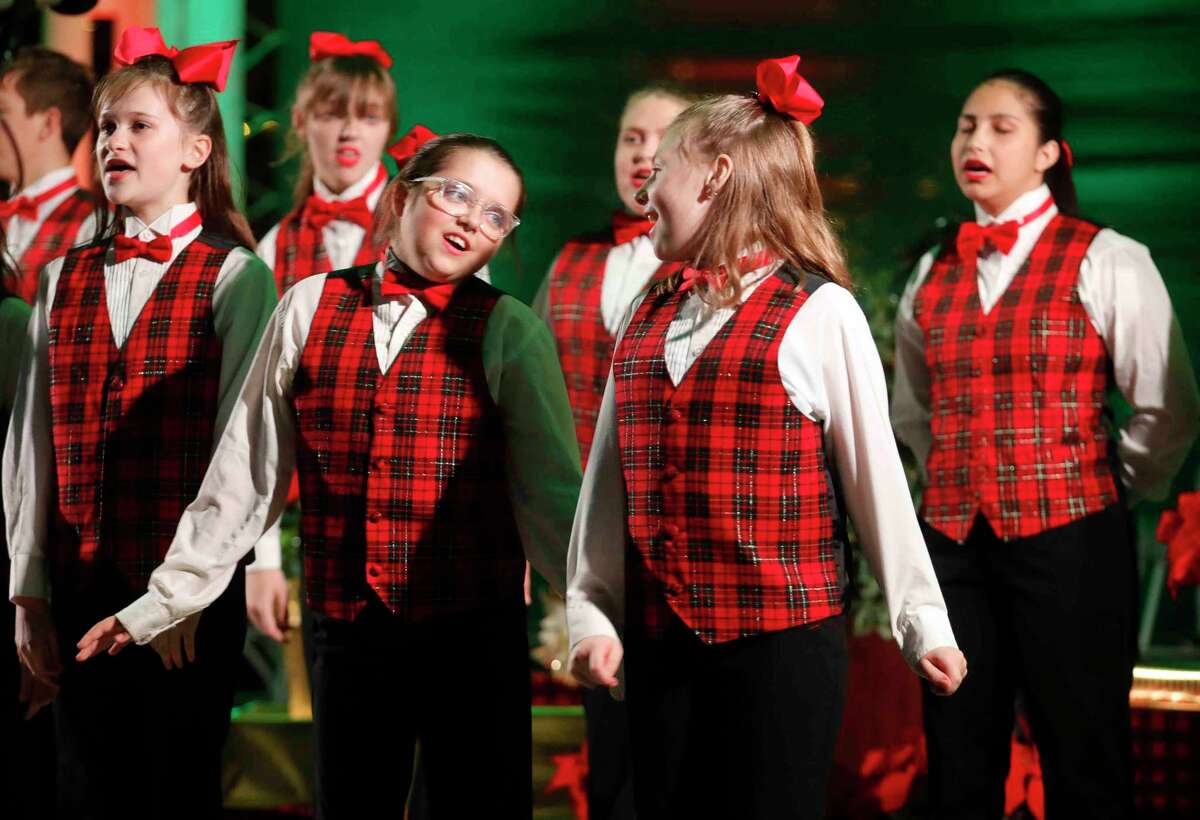 Members of the Joyful Sound Homeschool Choir sing during the Conroe Christmas Tree Lighting event in Heritage Park, Tuesday, Nov. 30, 2021, in Conroe. 