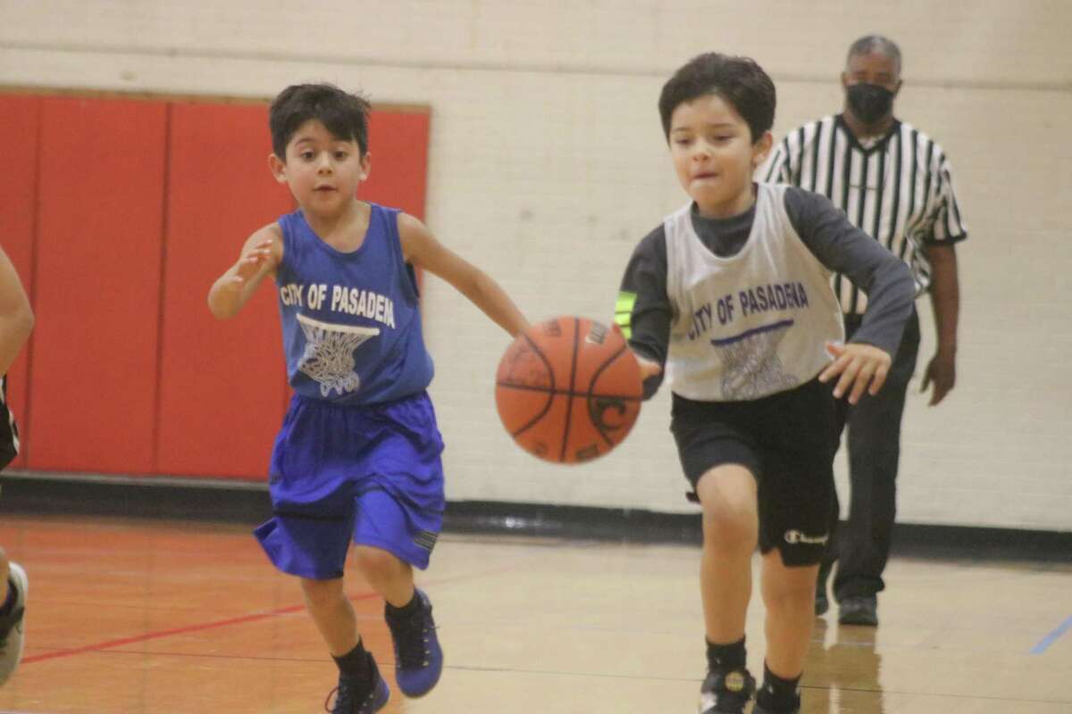 As a defender gives chase, another youngster has apparently learned the fundamentals of dribbling very well. This scene came from last season's action at PAL Gym.