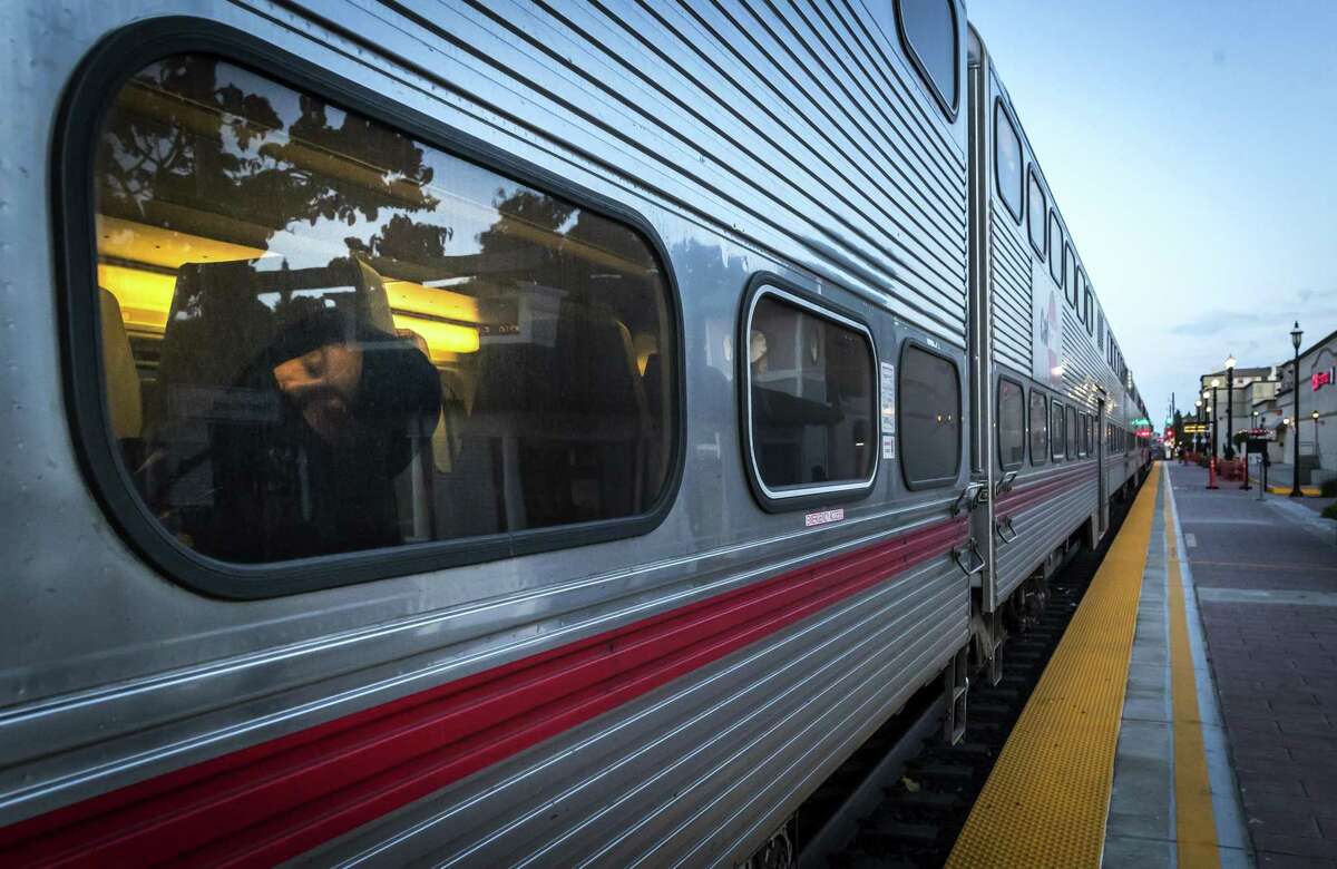 A passenger naps against the window of the train stopped at Caltrain Sequoia Station Shopping Center in Redwood City.The 12-acre property is poised for a major redevelopment.