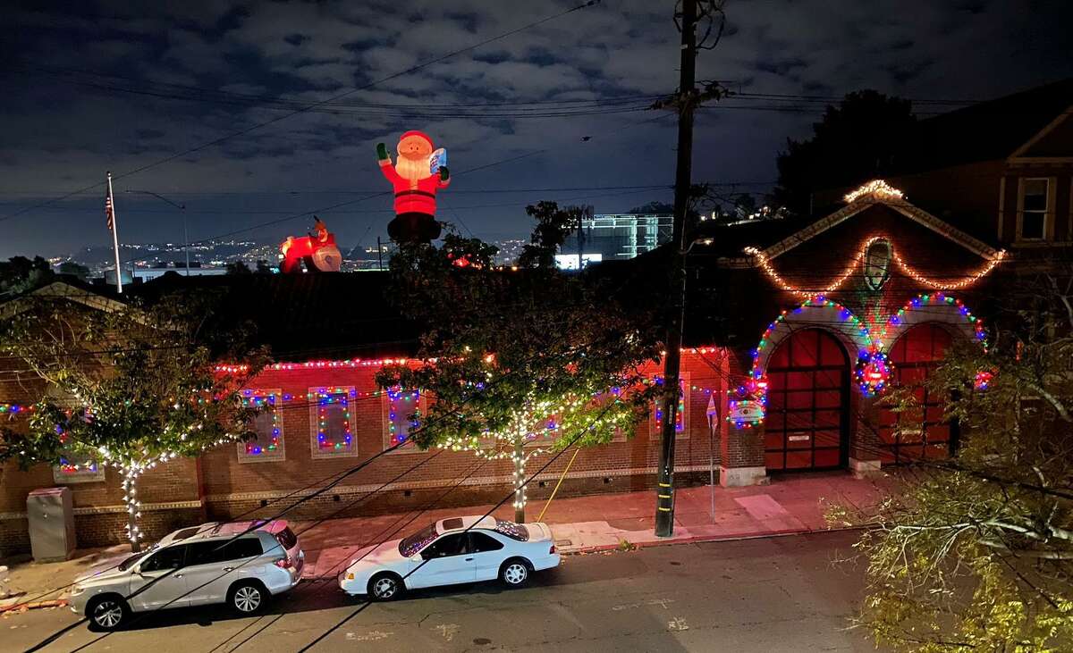 The San Francisco Fire Department Bureau of Equipment is decorated for a 2020 fire decoration contest, including lights on a classic fire engine.