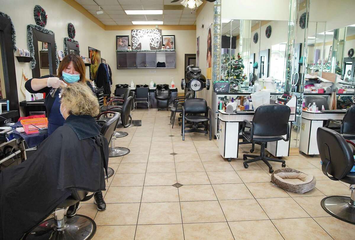 Arena Salon II owner Sue Mabsout works with her long-time client Cristina Giacaman, of Humble, at her Ulvade Road business on Tuesday, Nov. 30, 2021 in Houston. Mabsout has owned the salon for over 20 years, and has seen a huge change to the community that effects her business. “This place used to be packed all the time, we were open seven days a week,” said Mabsout, “now most of our clients are ones we’ve had for years, they left the neighborhood, but still make the drive.”