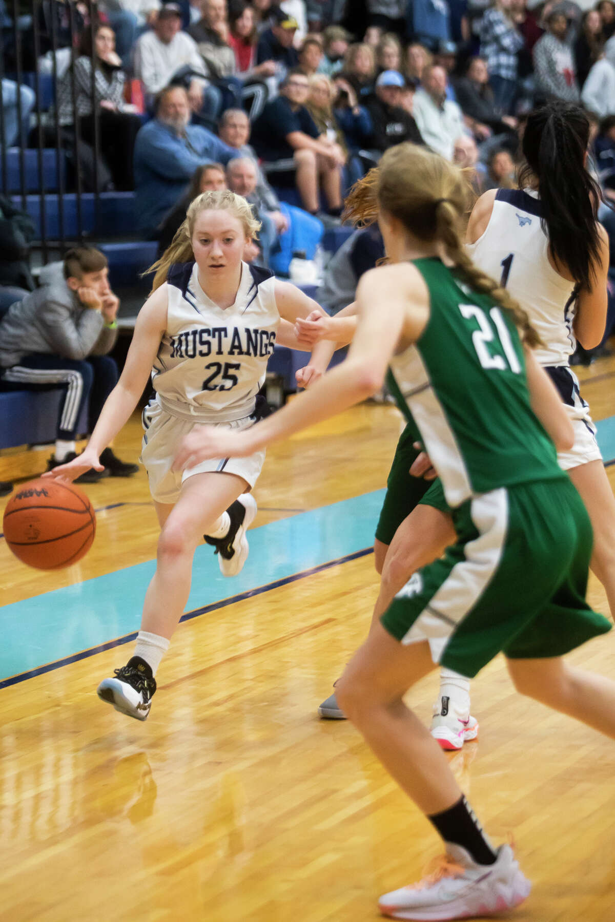 Meridian's Grace Chinavare dribbles down the court during the Mustangs' game against Freeland Tuesday, Nov. 30, 2021 at Meridian Early College High School.