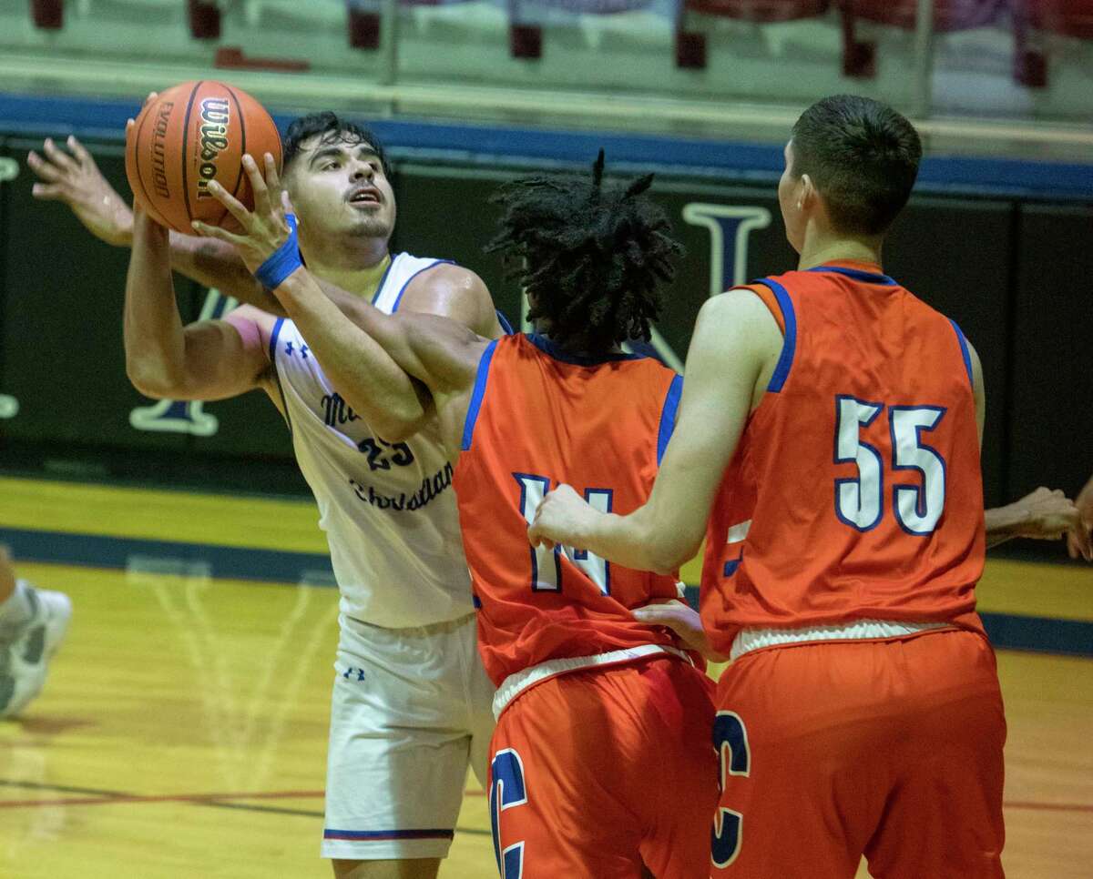 Midland Christian's Giovanni Lujan looks to put up a shot as San Angelo Central's Chace Fields, 14, and Kollin Allbright defend 11/30/2021 at the McGraw Event Center. Tim Fischer/Reporter-Telegram