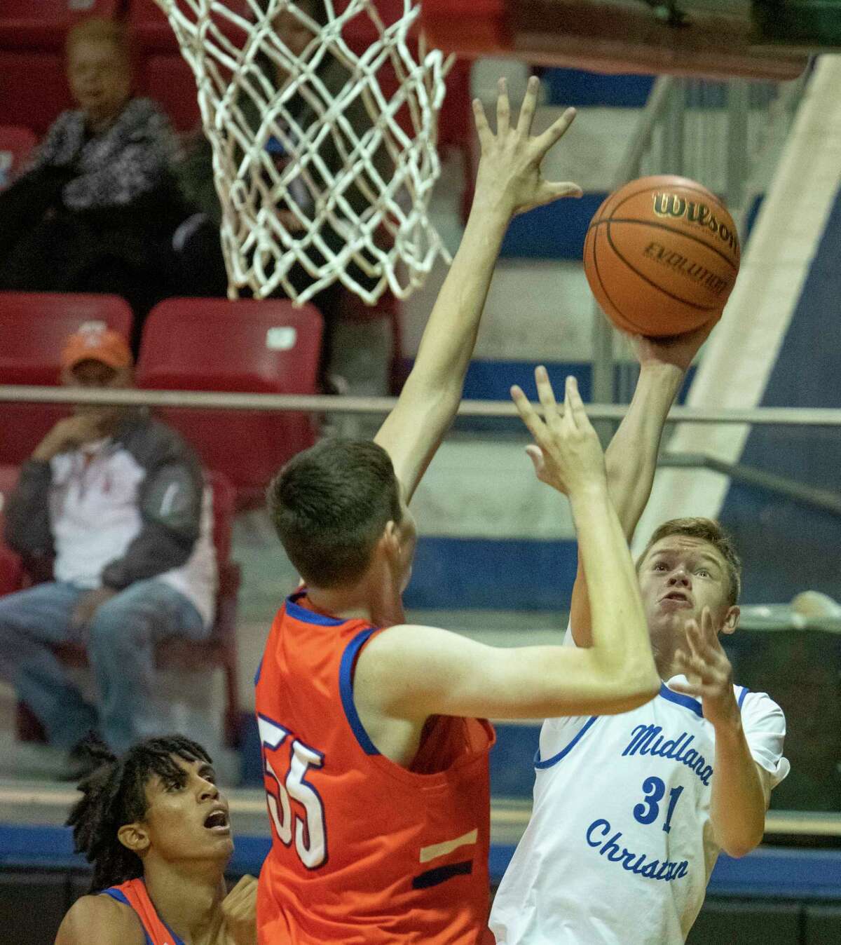 Midland Christian's Zach Day puts up a shot from the corner as San Angelo Central's Kollin Allbright defends 11/30/2021 at the McGraw Event Center. Tim Fischer/Reporter-Telegram
