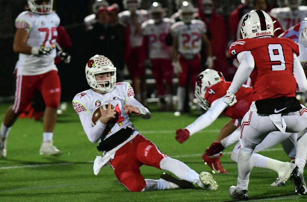 Greenwich quarterback Jack Wilson (14) gets hit late during the Class LL football playoff quarterfinal between the No. 8 Cardinals and the No. 1 Fairfield Prep Jesuits on Tuesday, Nov. 30, 2021, at Rafferty Stadium at Fairfield University in Fairfield, Conn.