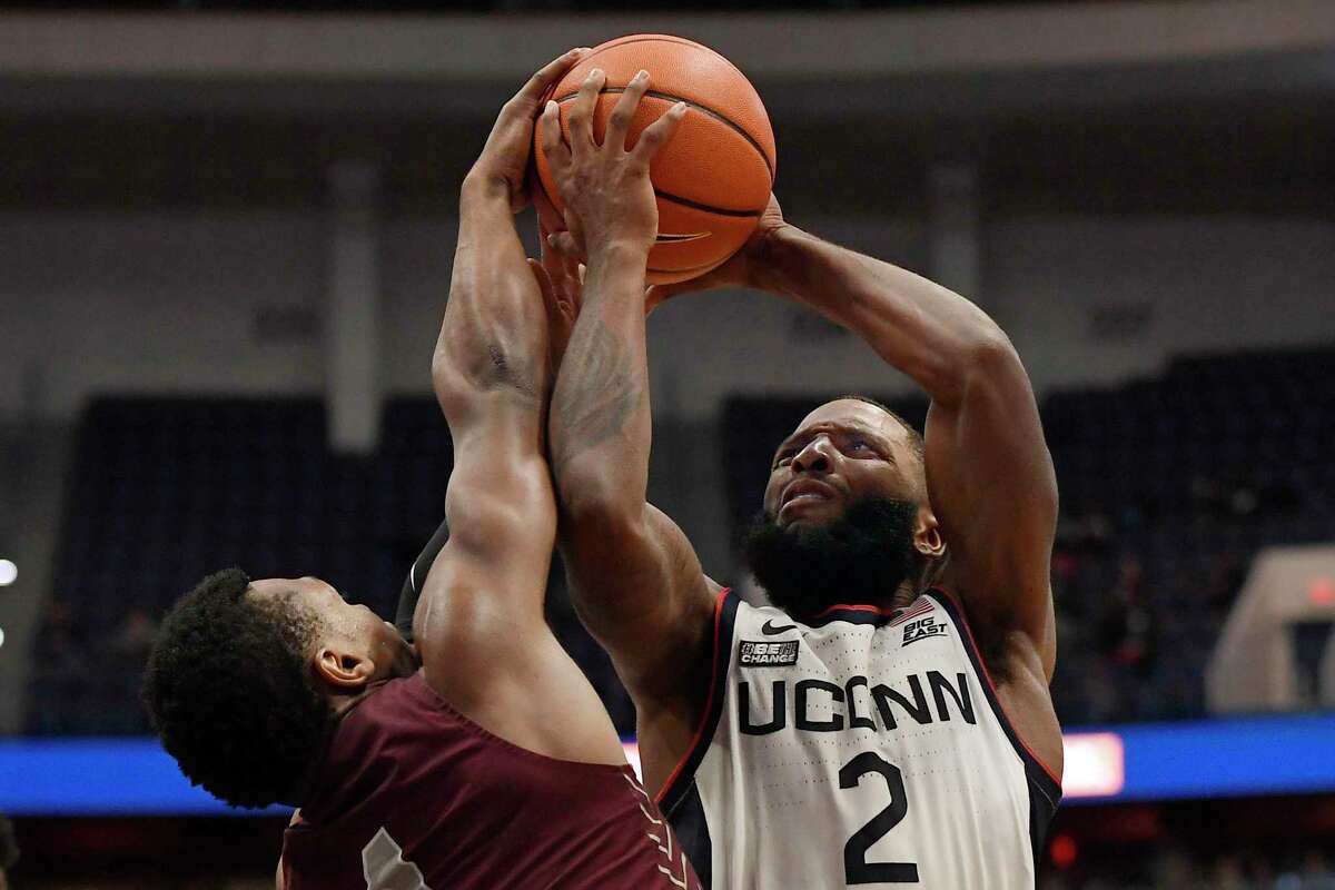 Connecticut's R.J. Cole, right, is fouled by Maryland-Eastern Shore's Donchevell Nugent in the second half of an NCAA college basketball game, Tuesday, Nov. 30, 2021, in Hartford, Conn. (AP Photo/Jessica Hill)