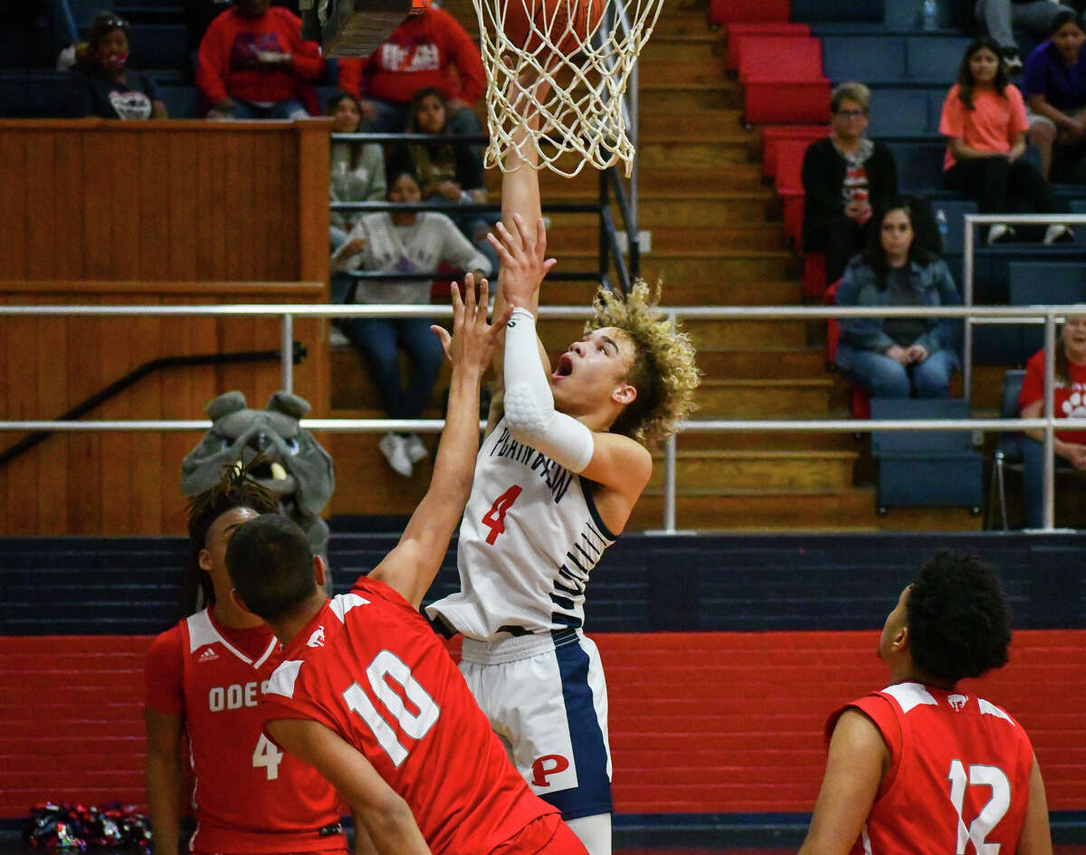 Plainview's Jaylynn Barrow gets up a shot attempt against Odessa defender Ivan Carreon during their non-district boys basketball game against Odessa on Tuesday in the Dog House. 