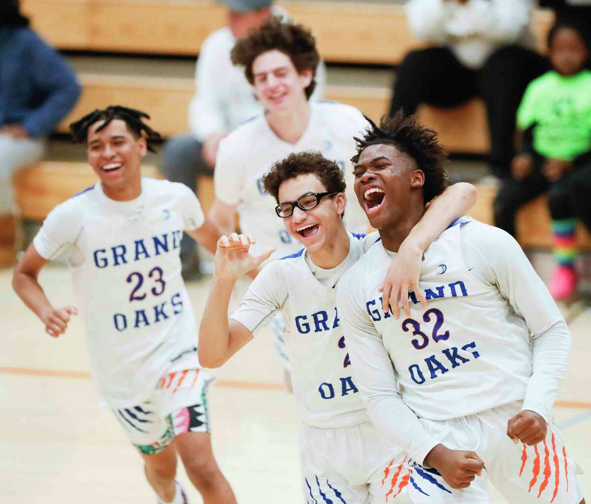 Grand Oaks forward Sammuel Nkassa (32) celebrates after hitting a shot at the buzzer to give the team a 61-59 win over Lake Creek during a non-district high school basketball game at Grand Oak Ridge School, Tuesday, Nov. 30, 2021, in Spring.