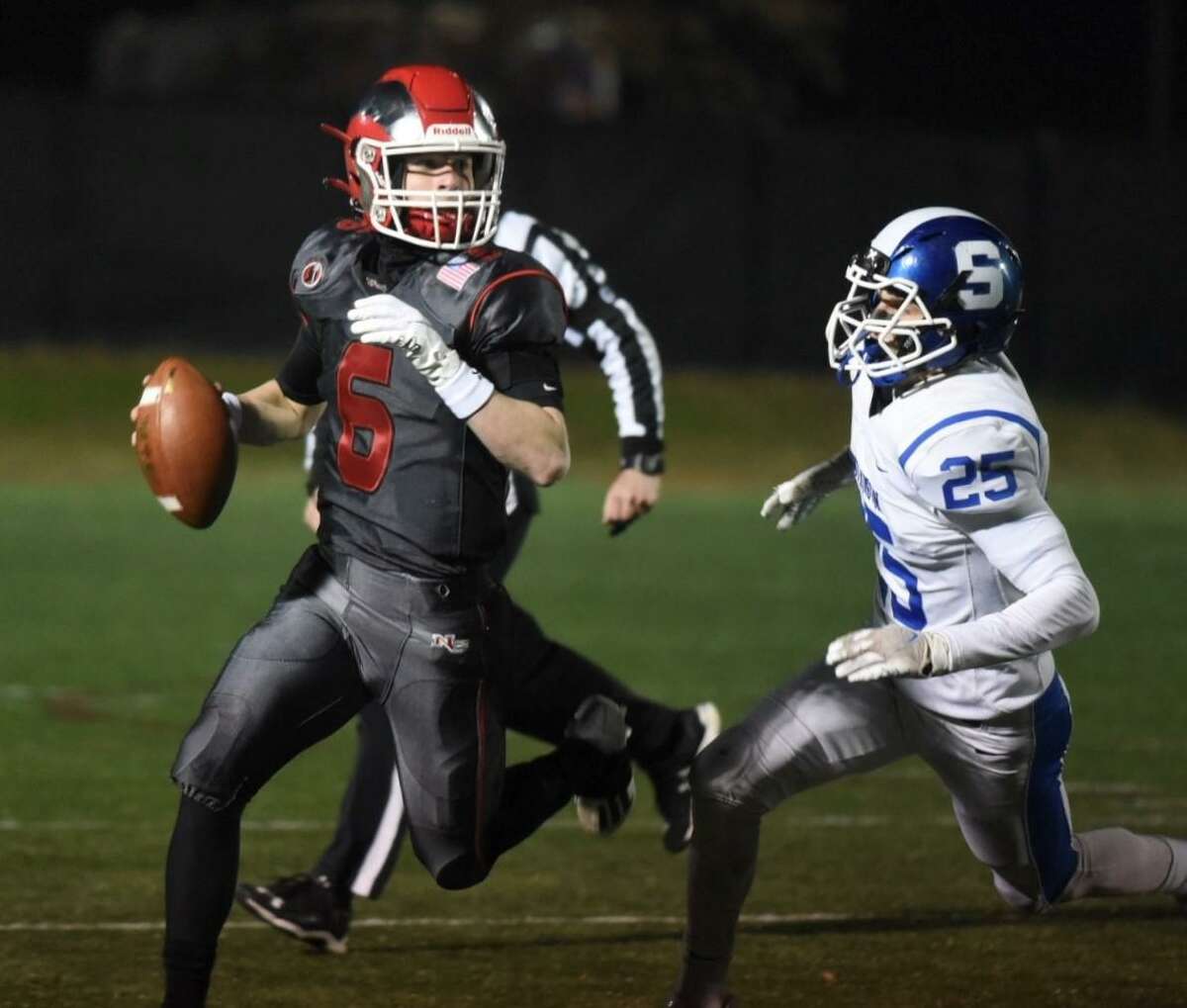 New Canaan quarterback Henry Cunney (6) is pursued by Southington’s Jared Guida (25) during a CIAC football quarterfinal on Tuesday, November 30, 2021 at Dunning Field in New Canaan, Conn.
