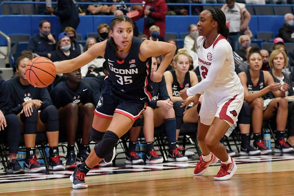 Connecticut's Azzi Fudd and Arkansas' Samara Spencer (2) in the second half of an NCAA college basketball game, Sunday, Nov. 14, 2021, in Hartford, Conn. (AP Photo/Jessica Hill)