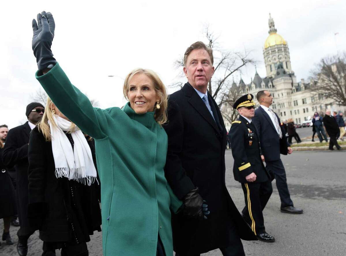 Governor Ned Lamont and his wife, Ann, walk in a parade after his swearing in outside of the Capitol Building in Hartford on January 9, 2019.