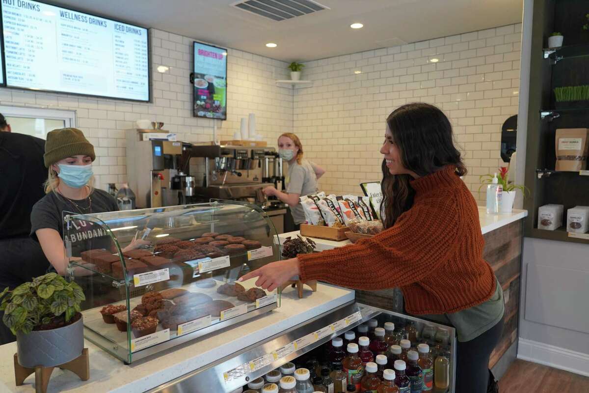 Pauline DiGorgio points out the treats at Green & Tonic, which opened its doors on Forest Street in New Canaan on Nov. 29, 2021.