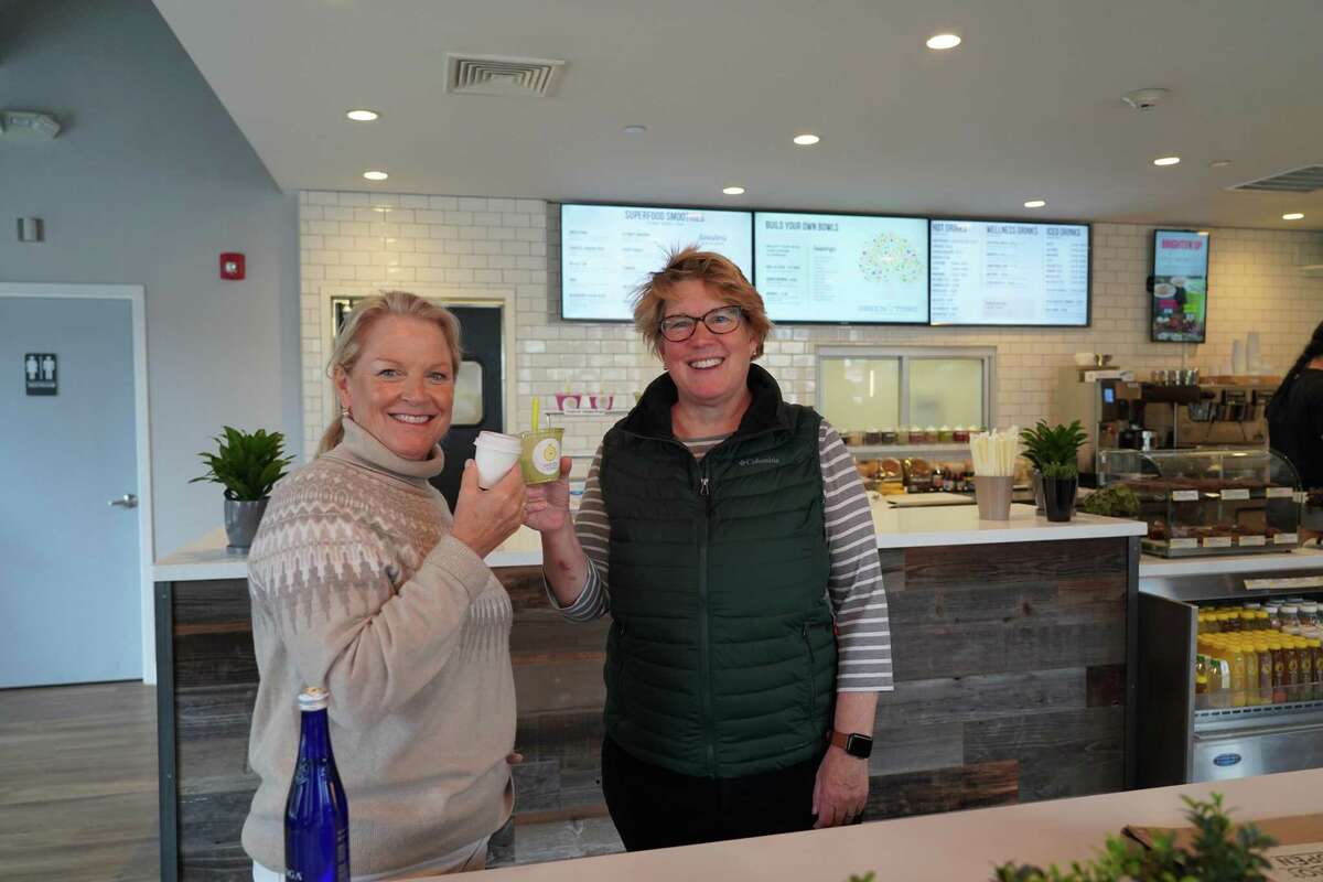 Administrative Officer Tucker Murphy and Executive Director of the New Canaan Chamber of Commerce Laura Budd are appreciating goodies at Green & Tonic, which opened its doors on Forest Street in New Canaan on Nov. 29, 2021. The eatery will offer healthy grab-and-go food.