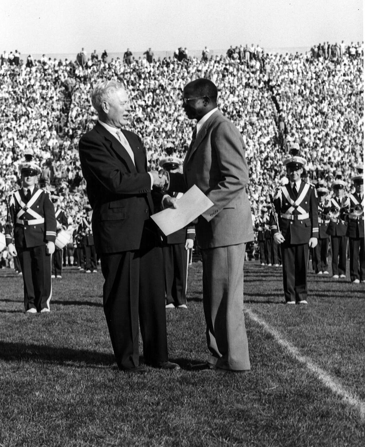 Gideon Gideon (right) was honored, with the rest of the team, at halftime of 1953 MSU game on the 40th anniversary of their 1913 unbeaten season.