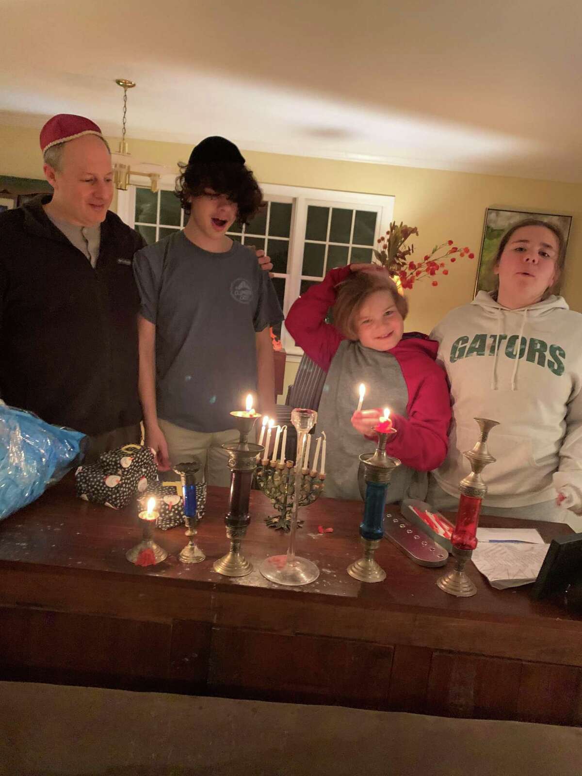 Ian, Louis,George and Selma lighting the menorah for the endless holidays at the Haft household.