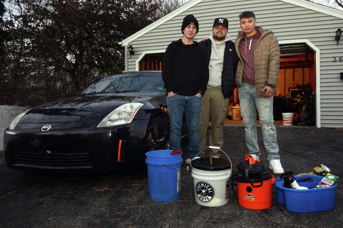 From left, Gary Saffersein, Dilahn Isaku and Tyler Borer of TDG Auto Detailing, in Milford, Conn. Nov. 29, 2021.