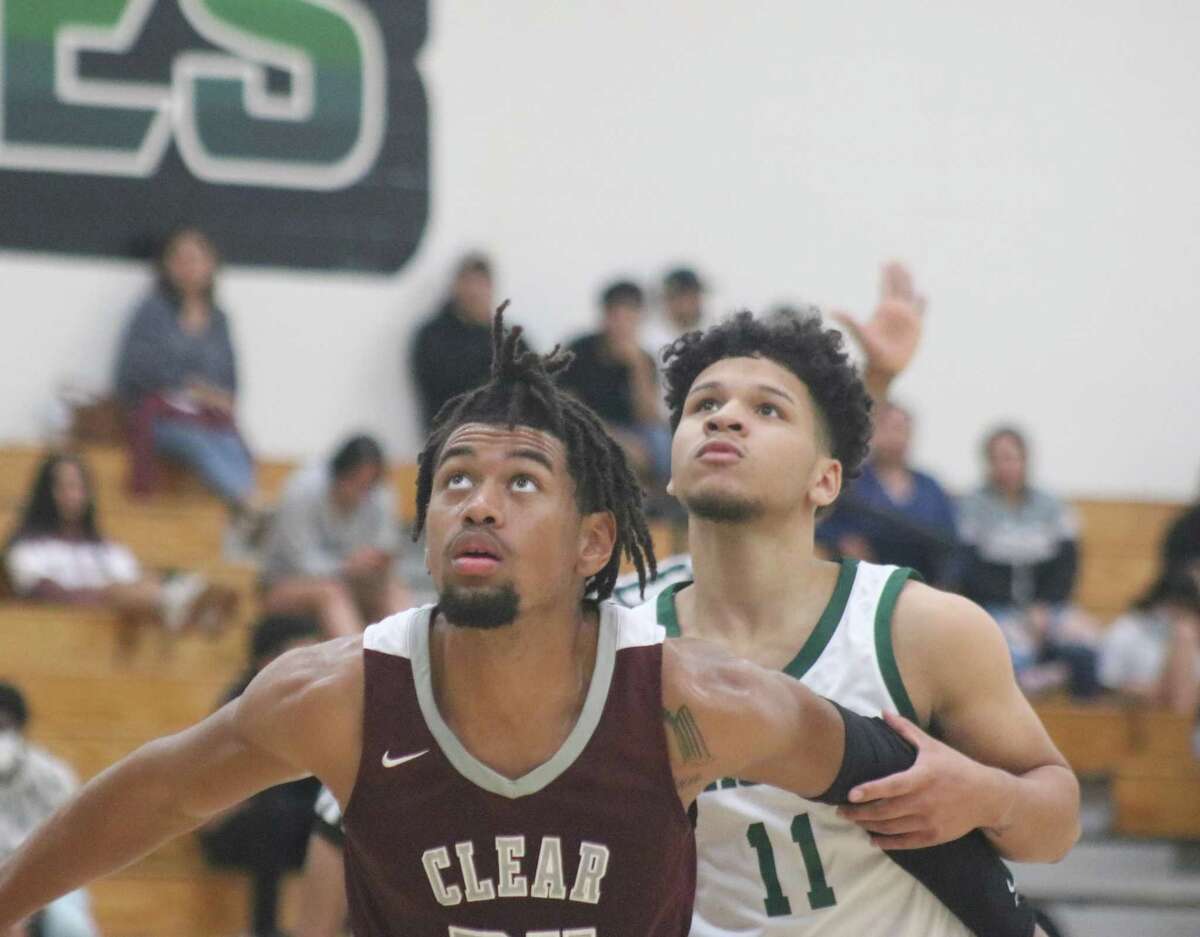 Clear Creek's Jeremiah Cams tries to hold back Pasadena's Ke'Shawn Hassell as a foul shot is taken during second-half action Tuesday night.