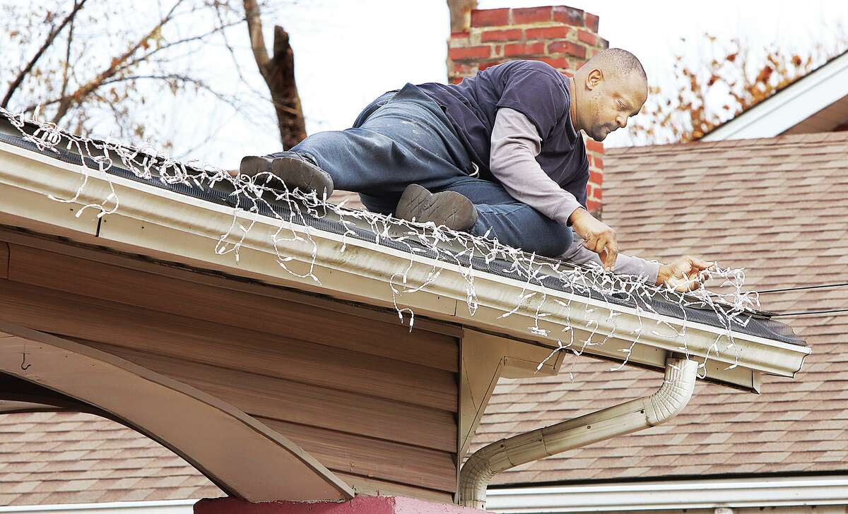 John Badman|The Telegraph Keith Brown was working to put up his icicle Christmas lights this week in the 2300 block of State Street in Alton. Mother Nature has no immediate plans to create any icicles of her own with temperatures Thursday expected to reach 70 degrees.