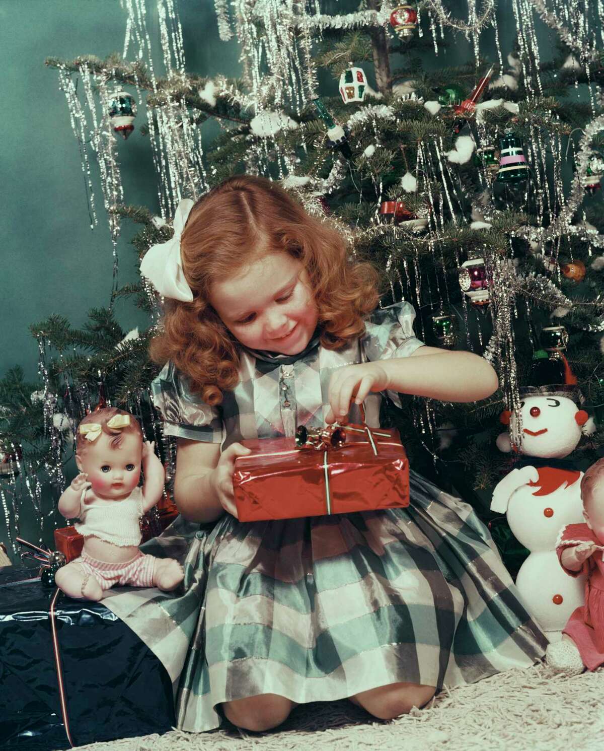 1950s: Photos from this decade surprisingly scrawny trees draped with plenty of tinsel.
