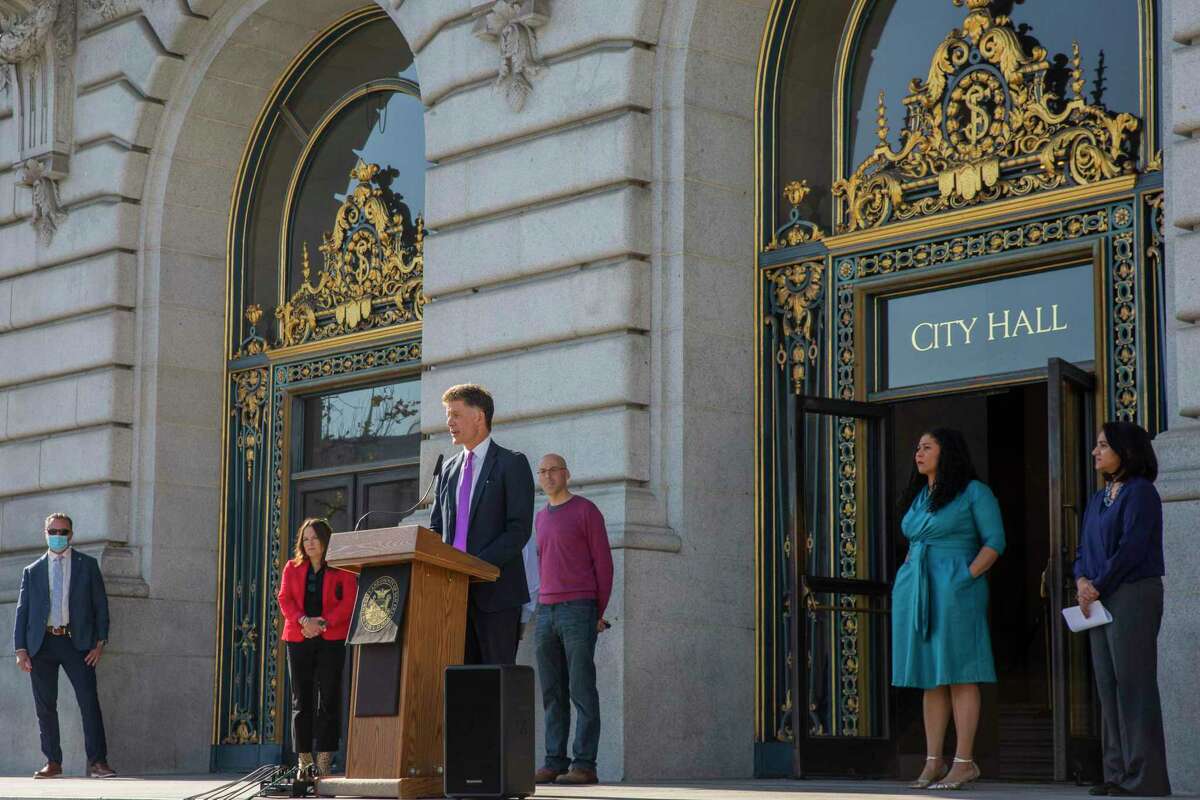 San Francisco officials are seen during a news conference Wednesday at City Hall, where they announced the nation’s first case of the omicron variant of the coronavirus.