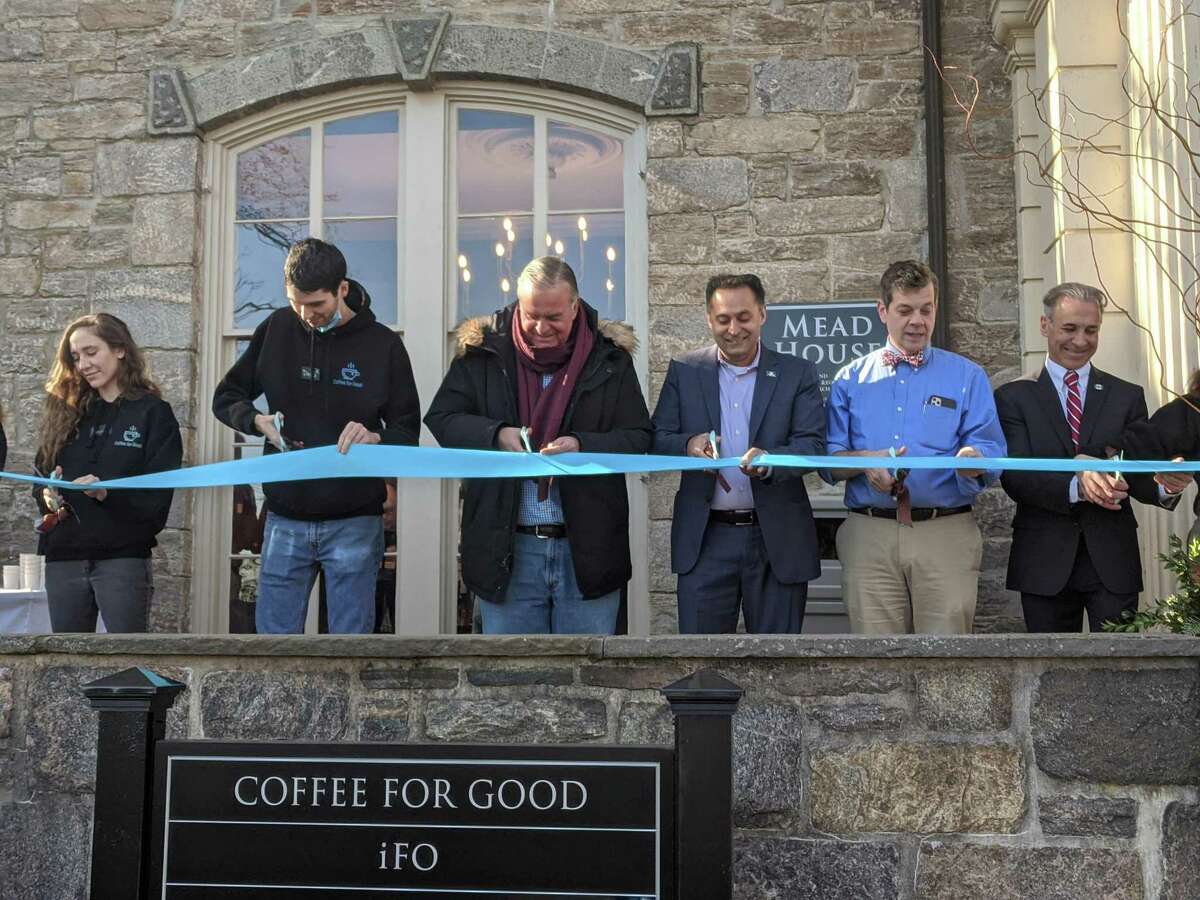 From left, Coffee for Good co-managers Emma Comesana-Vila and David Thompson join state Rep. Stephen Meskers, state Rep. Harry Arora, the Rev. Maxwell Grant of the Second Congregational Church and First Selectman Fred Camillo for the ribbon-cutting to mark the store’s official opening on Wednesday, Dec. 1, 2021.