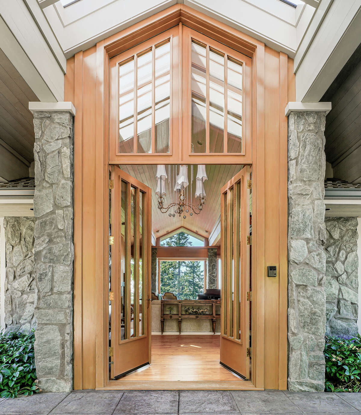 The stunning hand-crafted wood and glass entry is classic Ralph Anderson.