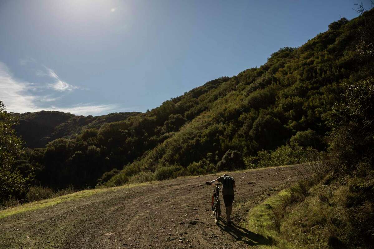 A cyclist ascends on Kennedy Trail during an annual Thanksgiving ride and gathering in Los Gatos on Thursday. A lingering high-pressure weather system is poised to bring the warmest start to December on record to a handful of Bay Area cities.