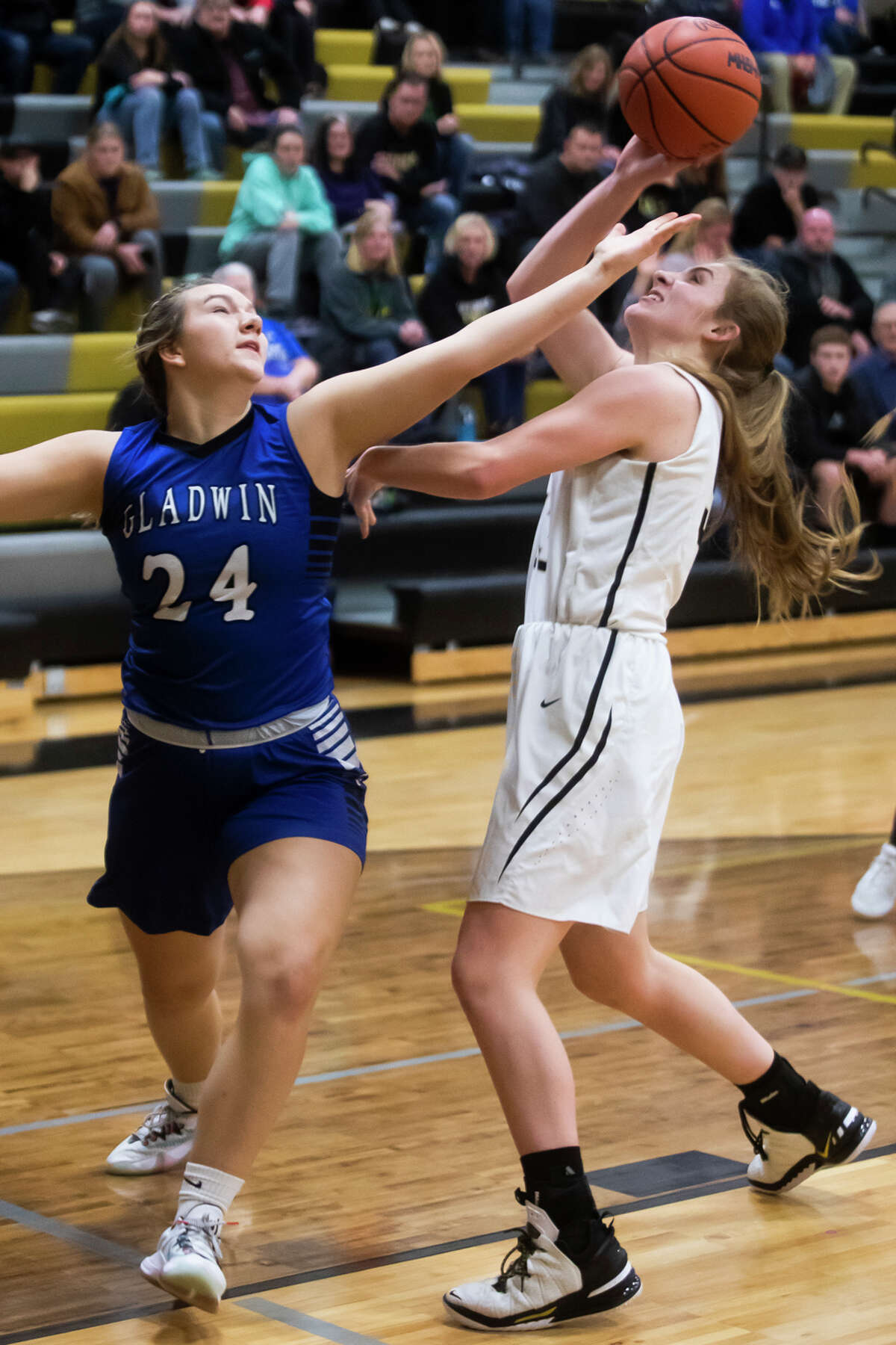 Gladwin's Delaney Reynolds and Bullock Creek's Daisy Schwartz fight for possession during their game Wednesday, Dec. 1, 2021 at Bullock Creek High School.