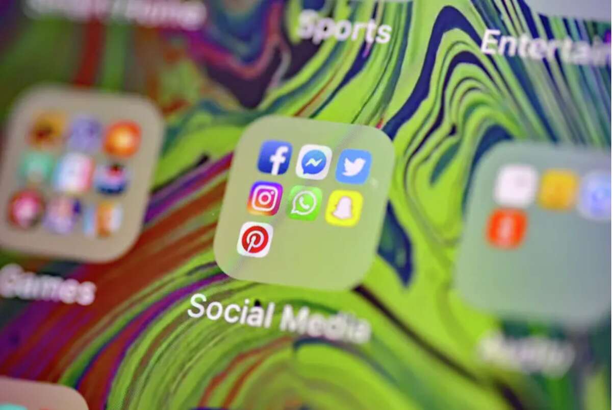 Social media app icons on a smartphone. 