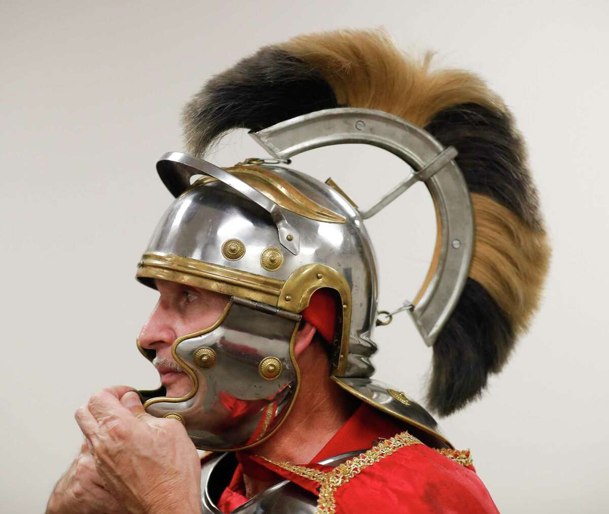 Jose Olivarez puts on his Roman guard helmet during a rehearsal for "Bethlehem City" at West Conroe Baptist Church, Wednesday, Dec. 1 2021, in Conroe. More than 100 actors reenactment scenes from Jesus' life in the drive-thru event which opens to the public Thursday and will run through Sunday for the next two weeks.