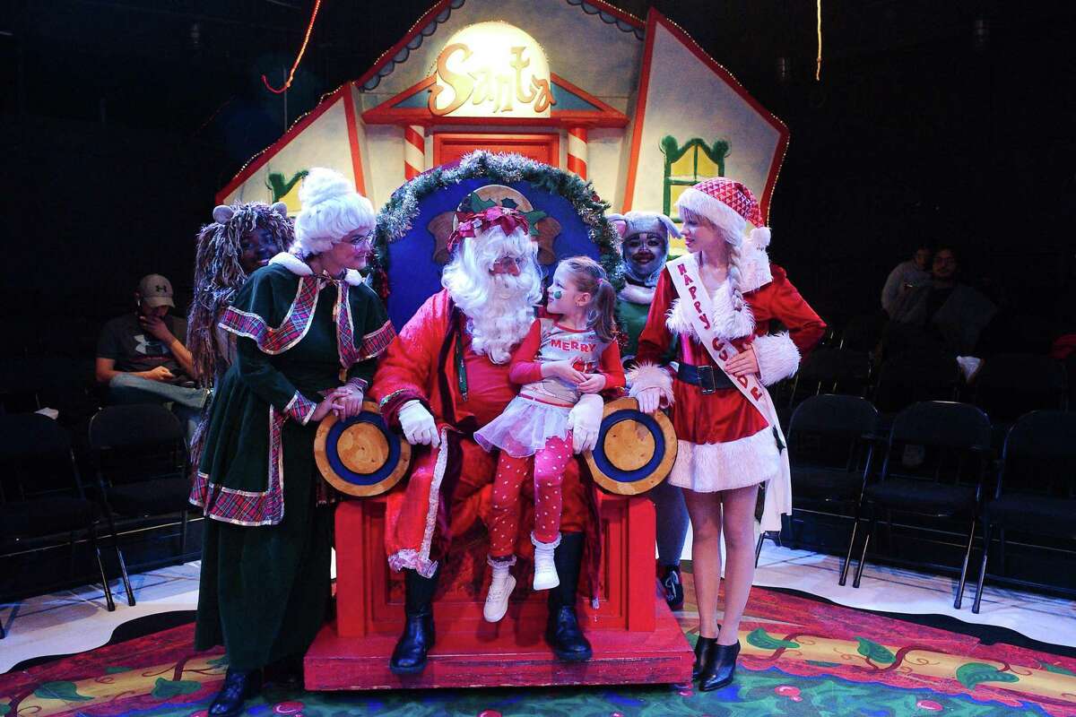 Santa and friends will invite young guests like Elizabeth Wood to chat with him at intermission during San Jacinto College Central performances of “Santa’s Christmas Magic: The Musical.” Also shown are, from left: Akeria Lewis as Lion; Olivia Martin as Ms. Claus; Anthony Gutierrez as Santa; Moneasha Rougeau as a mouse; and Rossi Uresti as Barbie.