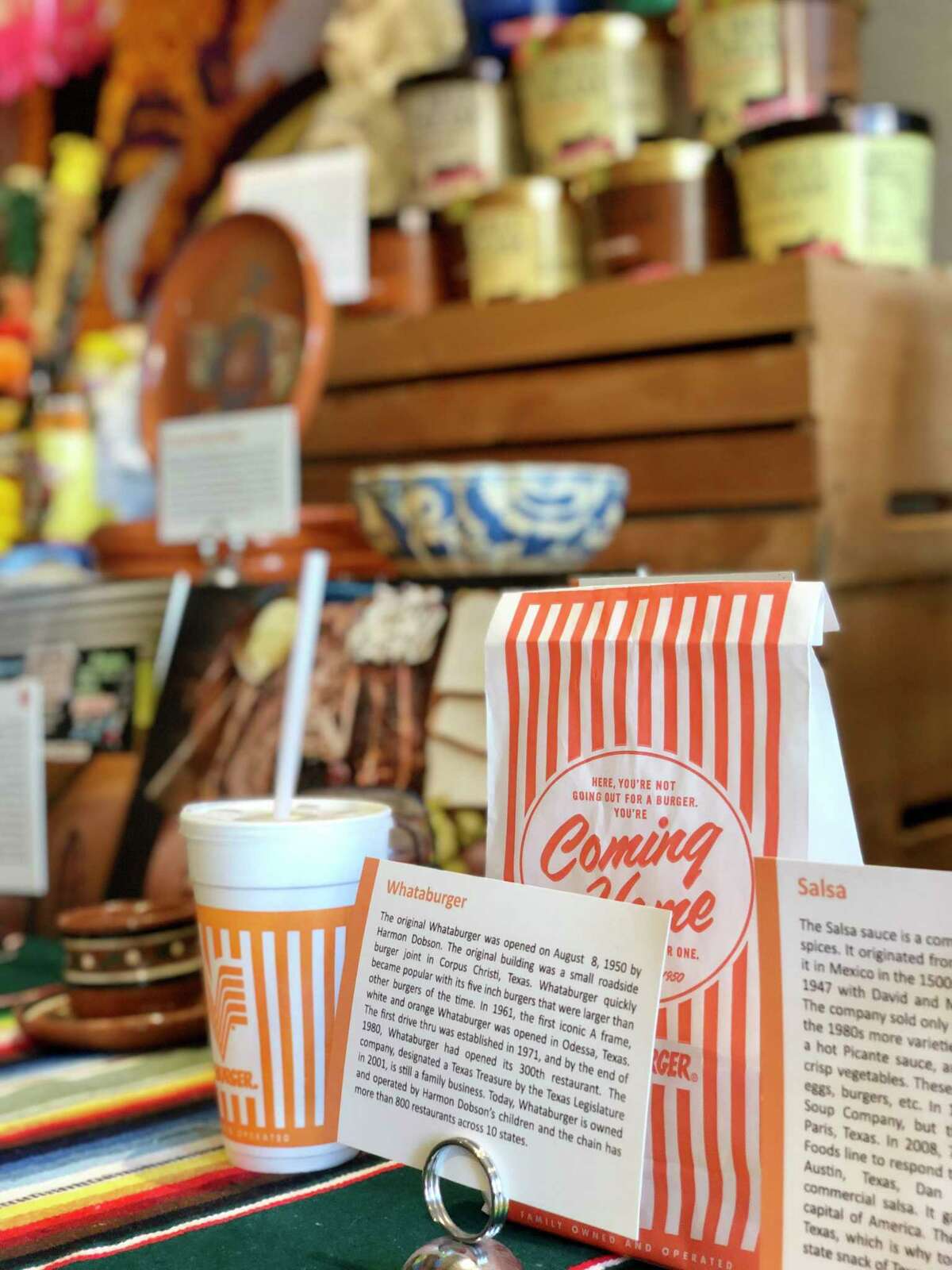 The museum’s Texas exhibit includes a Whataburger takeout bag and an empty soda cup from the burger chain.