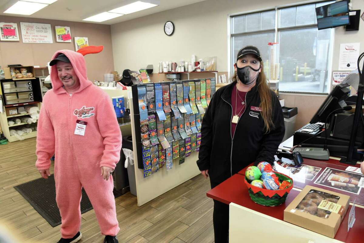 Stewart's manager Andy Basile, left, joke with assistant manager Barb Kay, right, while wearing a bunny suit styled after the one worn in the holiday classic, 'A Christmas Story' on Thursday, Dec. 2, 2021, at the Stewart's Shops convenience store on Columbia Turnpike in Schodack, N.Y. Kay sold customer Paul Webber 400 pints of ice cream in a fundraiser contest to feed the hungry. Basile wore the outfit as the grand prize.