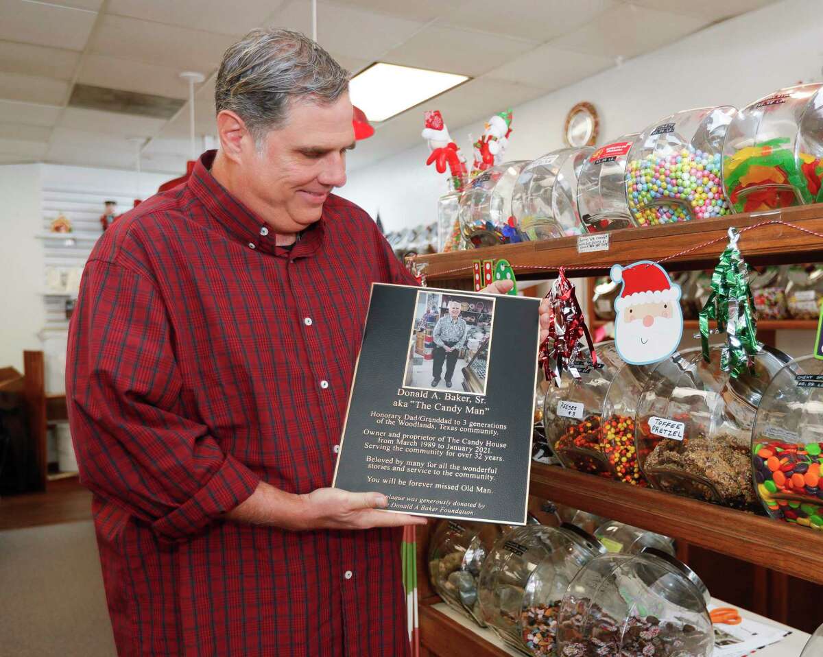 Donald Baker, Jr, holds a plaque honoring his father, Donald Baker, Sr., at The Candy House, Wednesday, Dec. 1, 2021, in The Woodlands.