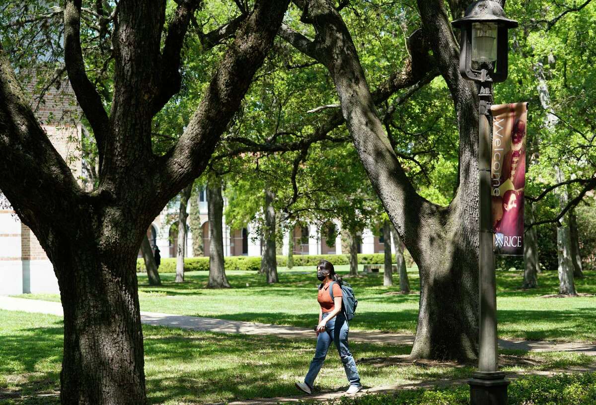 A person walks on the campus of Rice University is shown Thursday, April 1, 2021 in Houston. Rice University has announced an expansion of its student body and its campus. The physical expansion on the college’s 300 acres, will include a 12th residential college, a new engineering building, a building for the visual and dramatic arts, and a new student center that will largely replace the Rice Memorial Center.