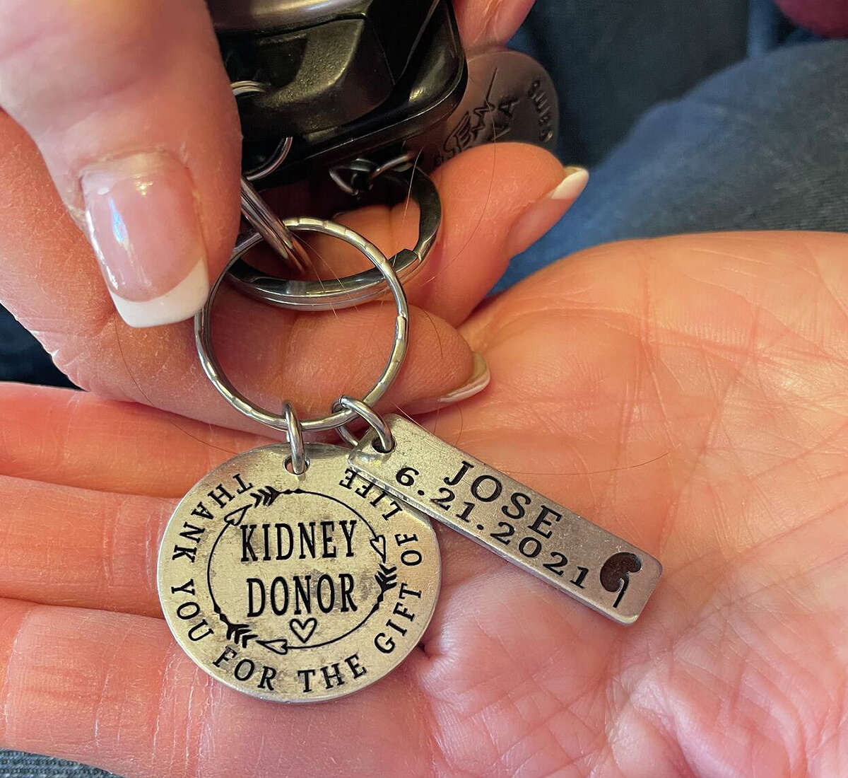Jose Cruz's wife, Amanda, gave Jamie Norton this kidney donor keychain with Jose's name on it and the date of the transplant.