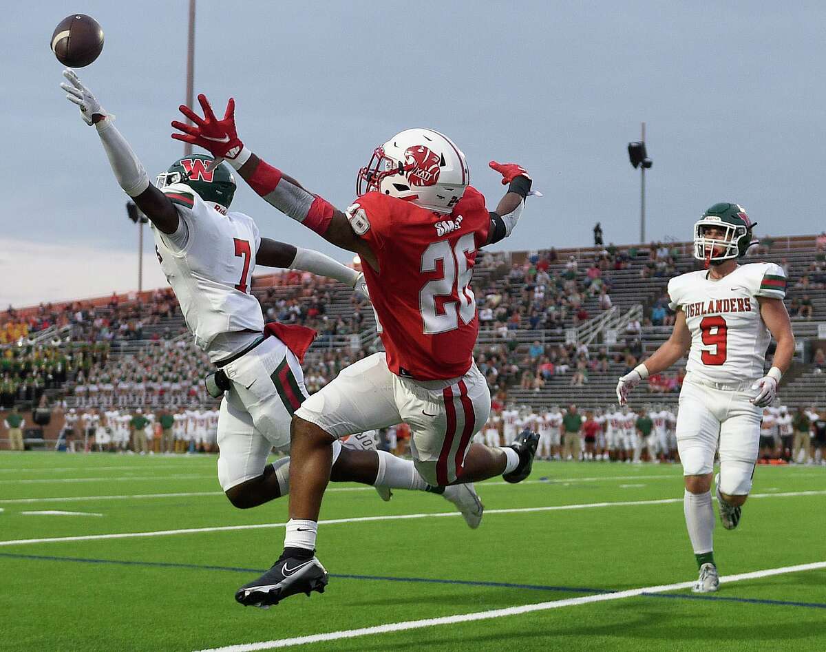 The Woodlands linebacker Martrell Harris, left, breaks up a pass intended for Katy running back Isaiah Smith (26) during the first half of a high school football game, Thursday, Sept. 16, 2021, in Katy.