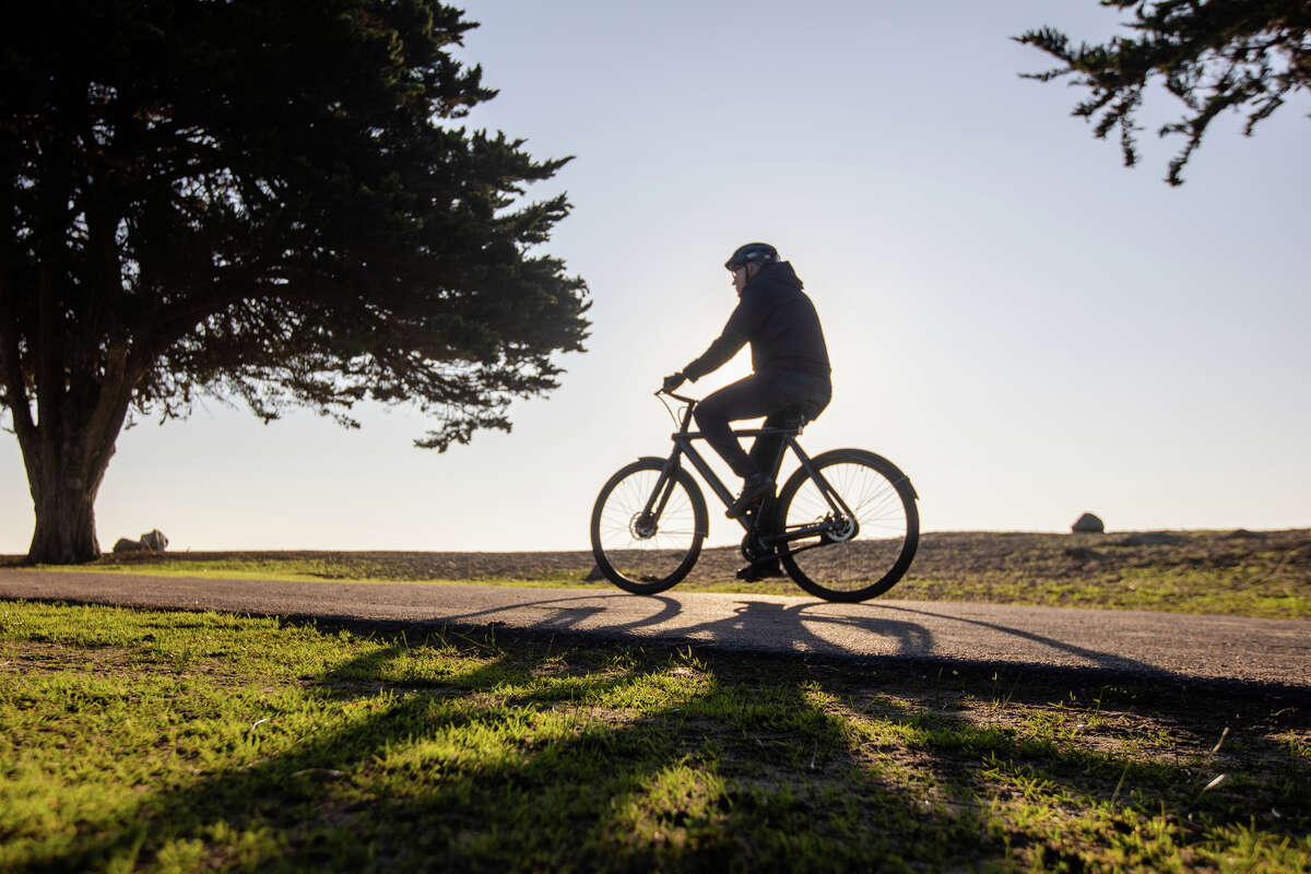 A mix of mild and warm weather is in the Bay Area forecast this week. In this file photo, a bicyclist rides through Robert W. Crown Memorial State Beach in Alameda, Calif.