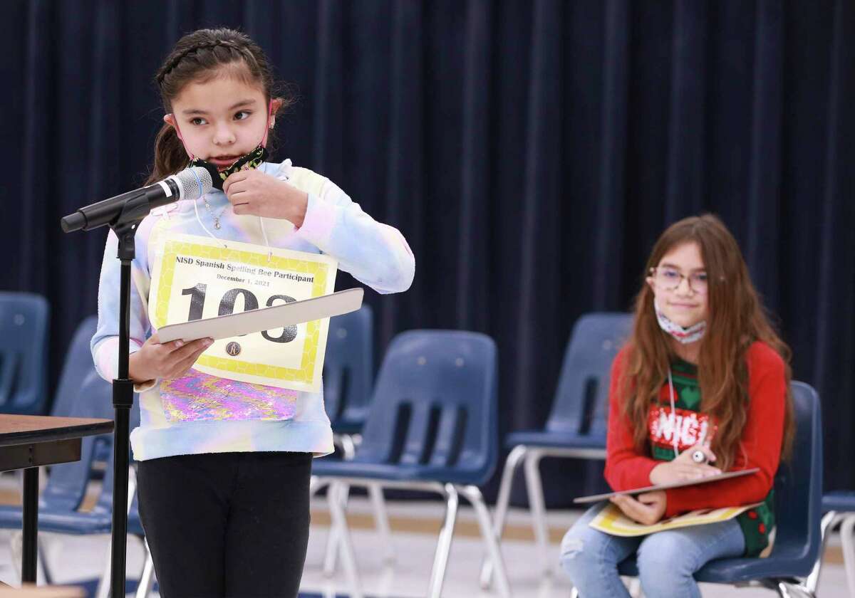 Leon Valley Elementary fifth-grader Valeria Chavez (left) spells the winning Spanish word "espuela" - meaning spur - to edge out runner-up Langley Elementary fifth-grader Marina Melendez in Northside ISD’s Spanish spelling bee Dec. 1.
