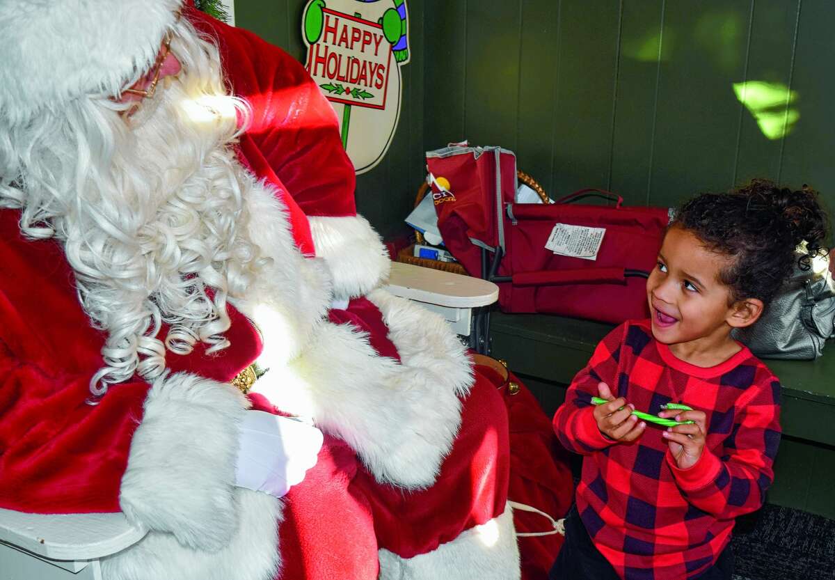Ericke Hildago, 3, visits Santa in December 2019 at his house on the downtown Jacksonville square. 
