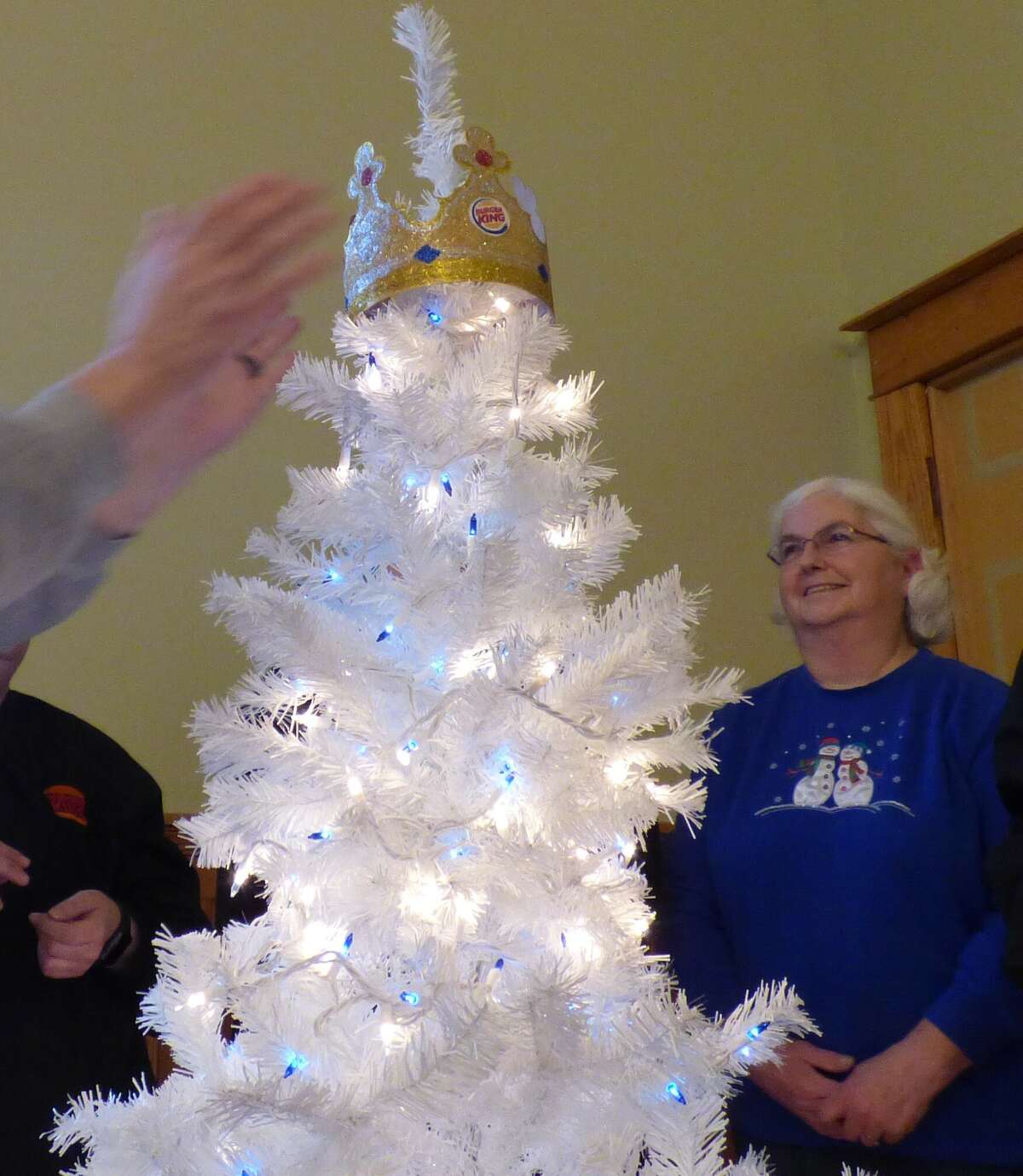 Staff from Manistee's Burger King, including Marie Baker, helped decorate a tree on Wednesday afternoon for the Festival of Trees.