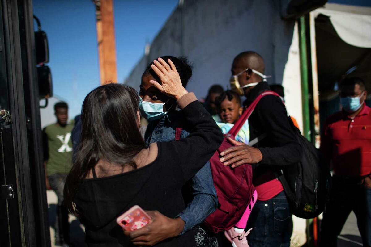 Laila Mtanous, lead of the Terraza Fandango shelter, places her hand on the forehead of a migrant as the young woman thanks her for the support she received at the shelter before getting in a bus to another Mexican town, Friday, Nov. 19, 2021, in Ciudad Acuña, Mexico.