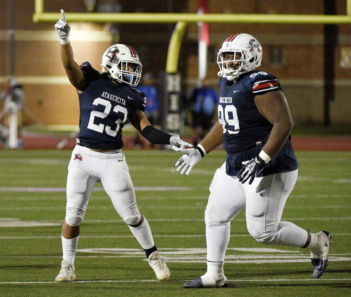 Atascocita linebacker Jadon Ducos (23) and defensive lineman Samu Taumanupepe (99) celebrate a fumble recovery during the second half of a high school football game against C.E. King, Saturday, Oct. 16, 2021, in Humble.