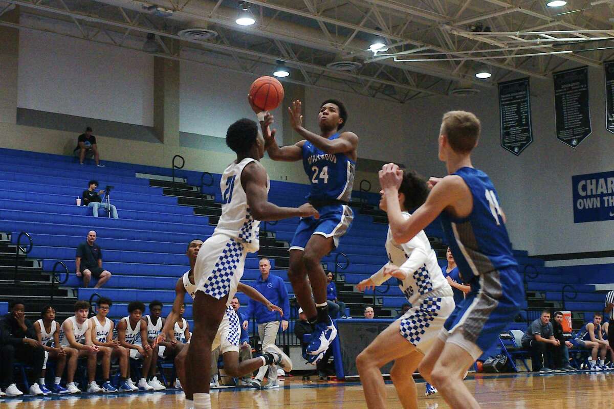 Friendswood’s Adam Buffington (24) puts up a shot over Clear Springs’ Michael Sylvalie (21) Thursday at Clear Springs High School.