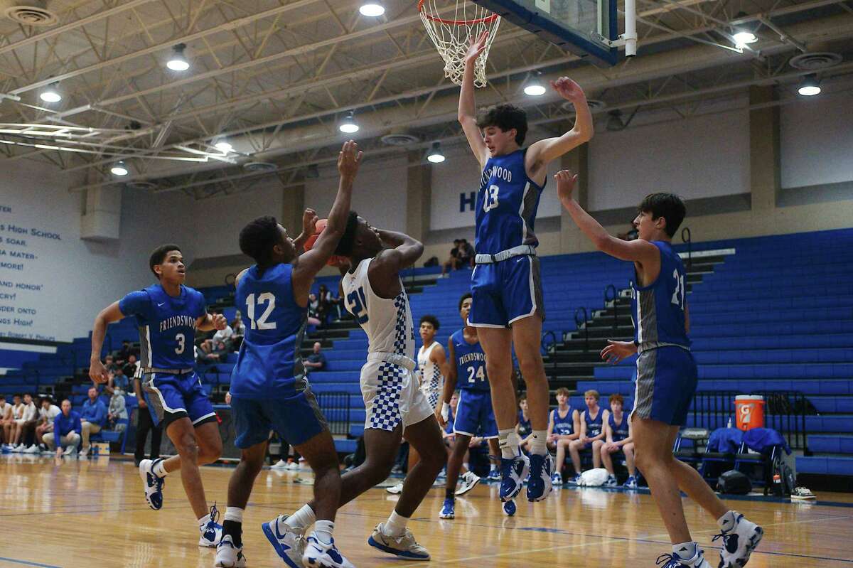 Clear Springs’ Michael Sylvalie (21) tries to put up a shot over Friendswood’s Keagan Robertson (13).